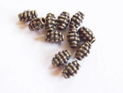 Pöttyös hordó köztes, antik bronz színű, 7x4 mm
