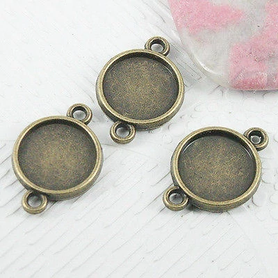 Kerek medálalap, összekötő, antik bronz színű, 21x14mm, 12 mm-es lencséhez