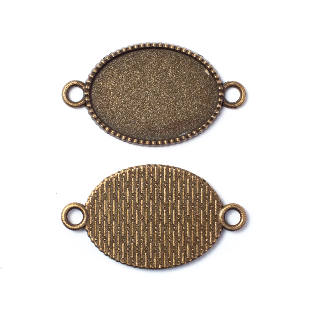 Ovális összekötő, medálalap, karkötőalap, 25x18 mm-es lencséhez, antik bronz színű, 36x20 mm