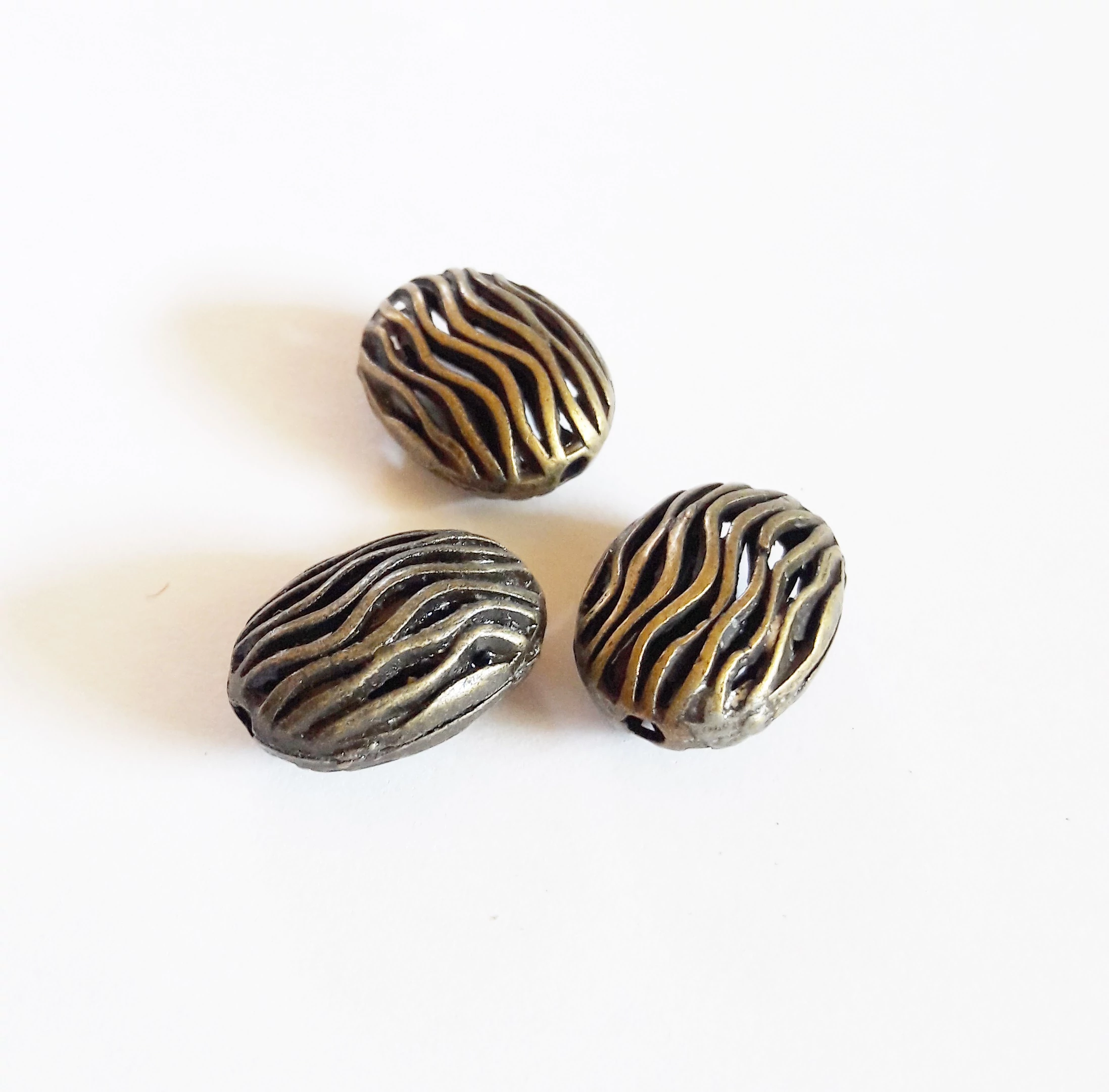 Hullámos ovális köztes, antik bronz színű, 17x12x8 mm