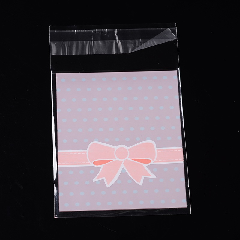 Rózsaszín masni mintás, pöttyös celofán tasak, ajándék zacskó, 12,5x8 cm